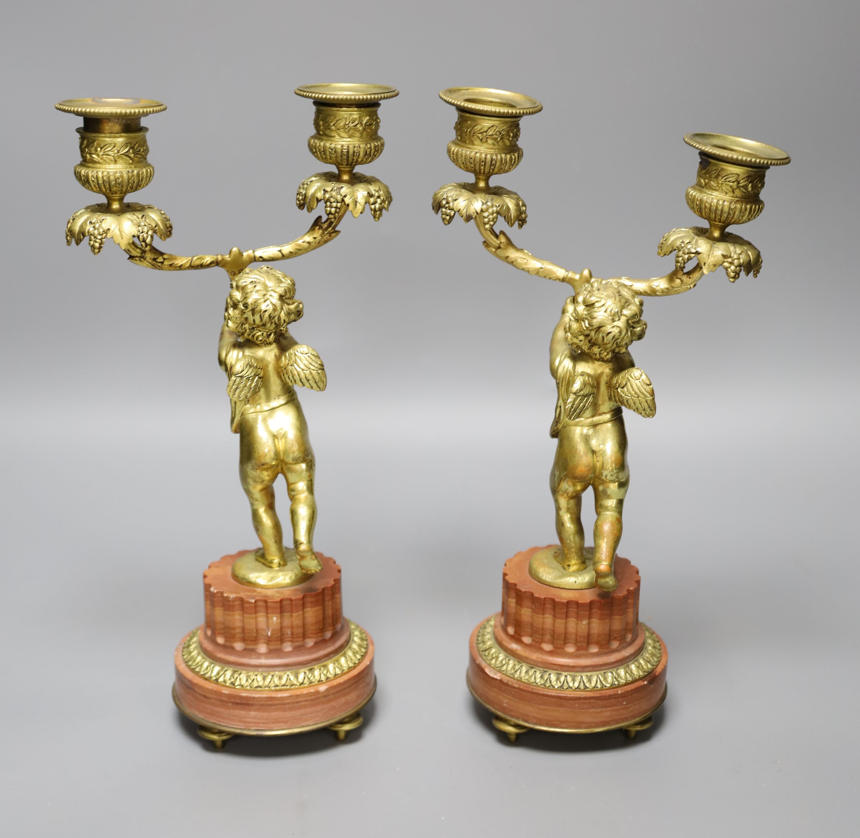 A pair of French ormolu cherub two branch candelabra, height 27.5cm